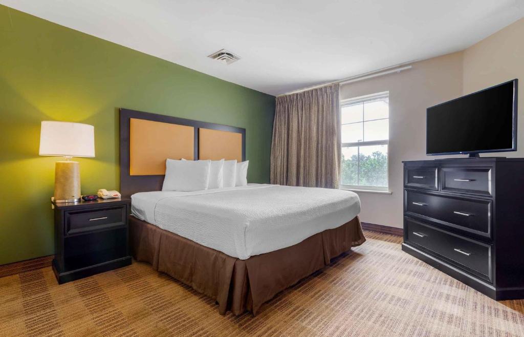 a bedroom with a bed and a flat screen tv at Extended Stay America Suites - Columbia - Northwest Harbison in Harbison