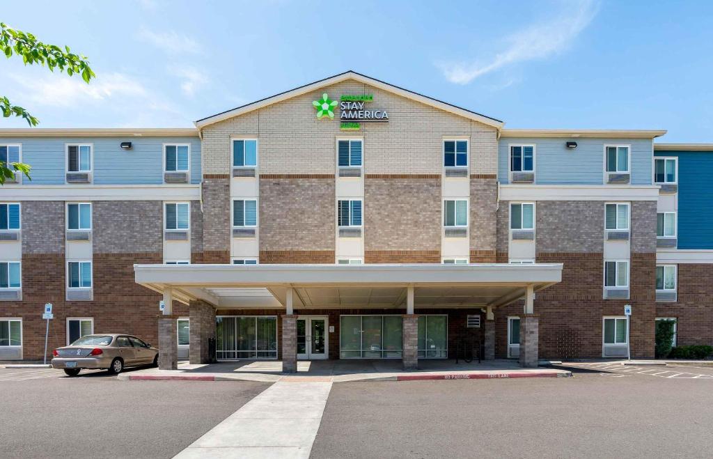 a hotel with a car parked in front of it at Extended Stay America Suites - Portland - East in Portland