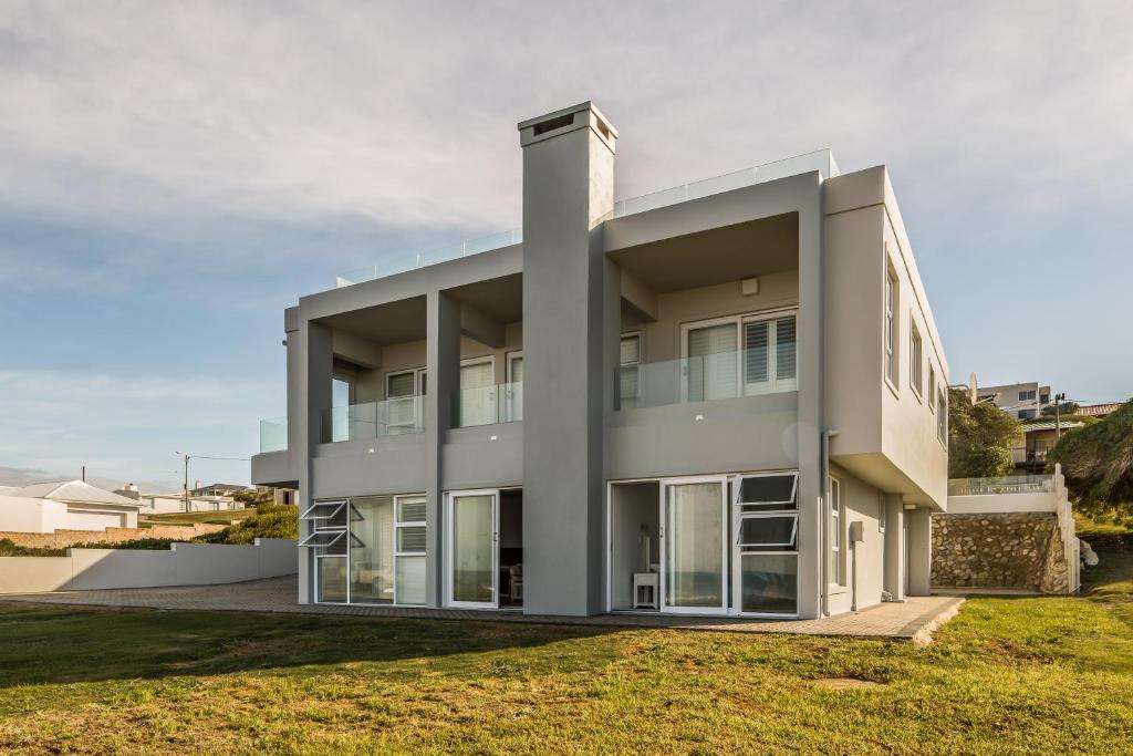 a large white building with large windows at 87 Marine Drive in Struisbaai