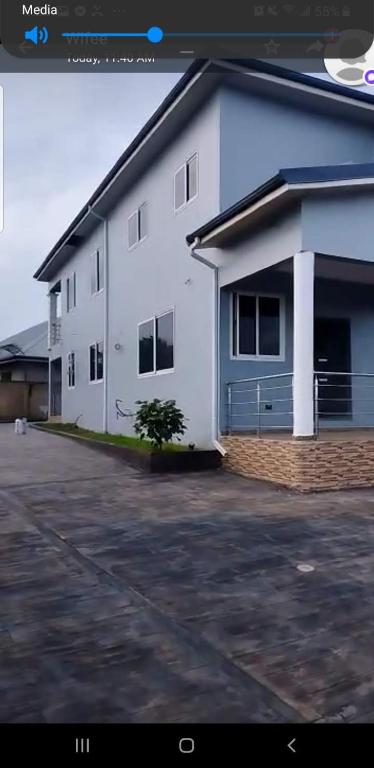 a white building with a parking lot in front of it at Fairview Executive Suites in Bawalishi