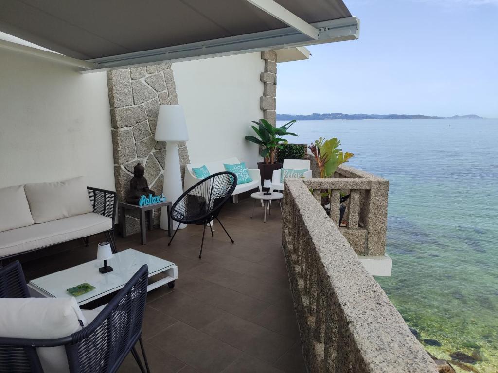 a living room with a view of the water at Principe in Sanxenxo