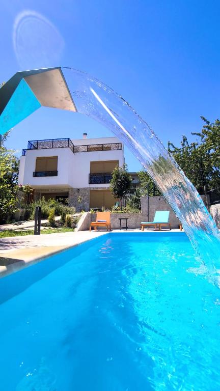 a water fountain in front of a swimming pool at B&B Hidden gem Blagaj in Blagaj