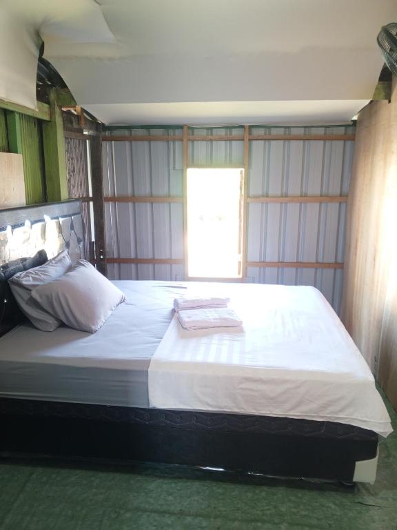 a bedroom with a large bed in a room at Jufri Homestay in Kasijala