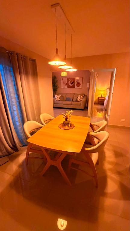 a dining room with a wooden table and chairs at Villa Yasmín - Apartamento Top in Villa Canales