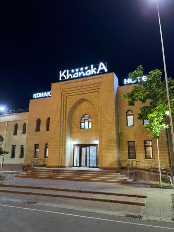 a building with a sign on the top of it at Hotel Khanaka in Türkistan