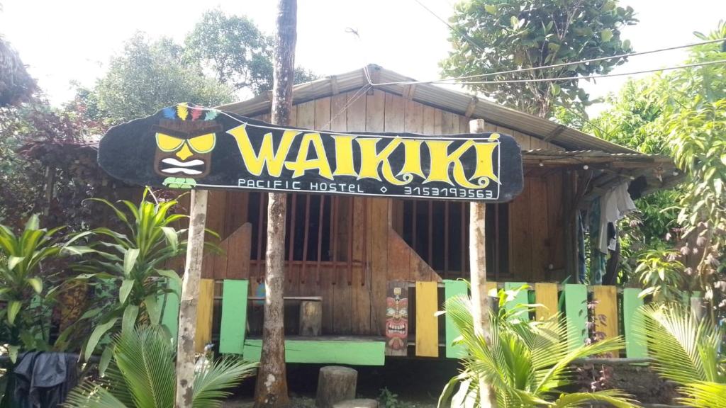 a sign in front of a small house at Waikiki Pacific Hostel in Buenaventura
