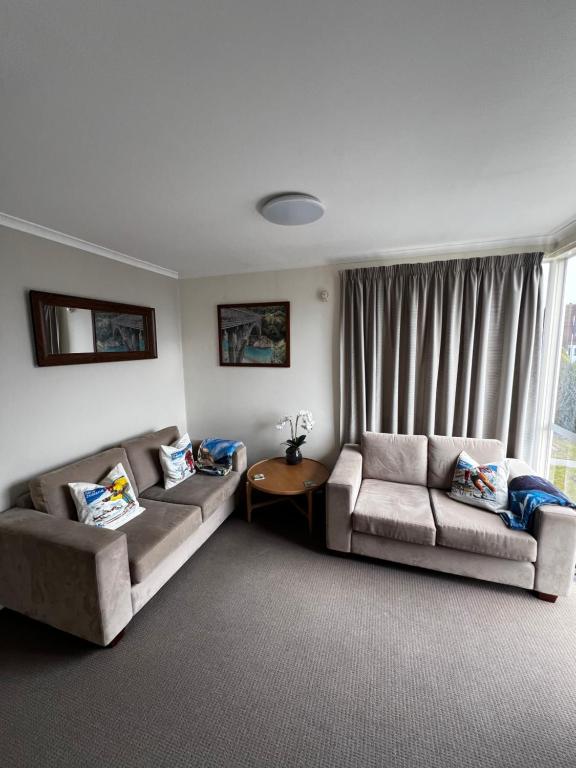 a living room with two couches and a window at Methven Mountain View Apartment in Methven
