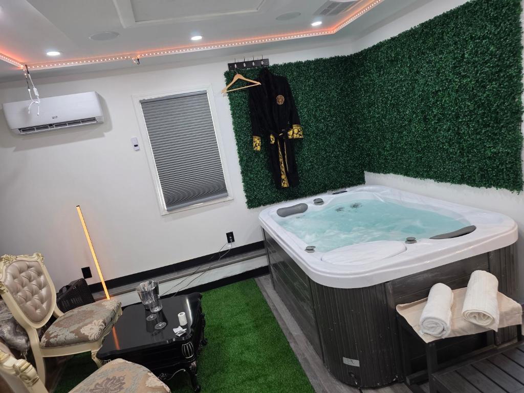 a bathroom with a tub with a green wall at Berwyn Alimot Proshortlet-home LLC in Syracuse