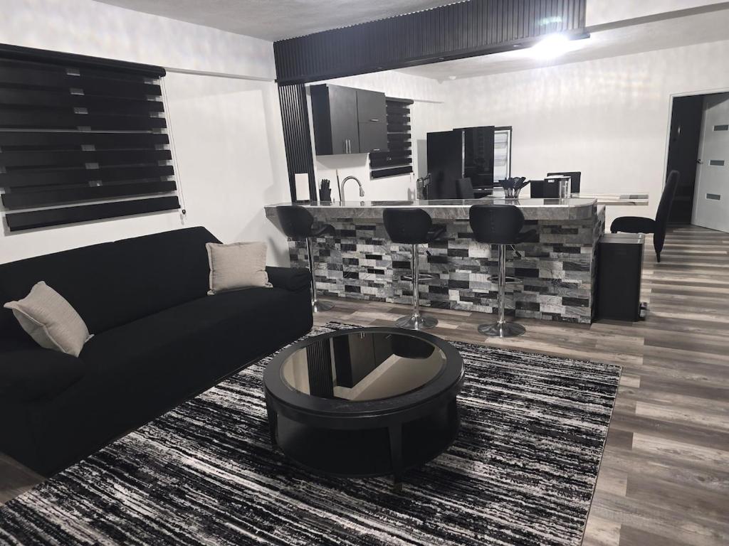 a living room with a couch and a table at Black House in Anasco