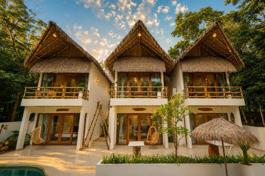 a villa with a view of a house at Ayana Lake Resorts in Kovillūr