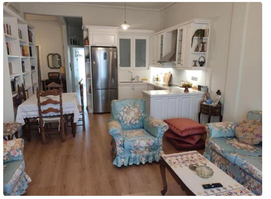 a kitchen and living room with a couch and chairs at Los Laureles A Relaxing Vintage Home in the Heart of Sparta in Sparta