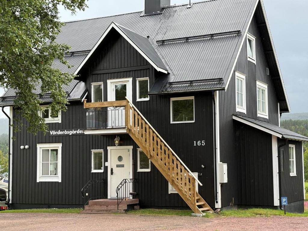 a black house with a metal roof at Vörderåsgården in Transtrand