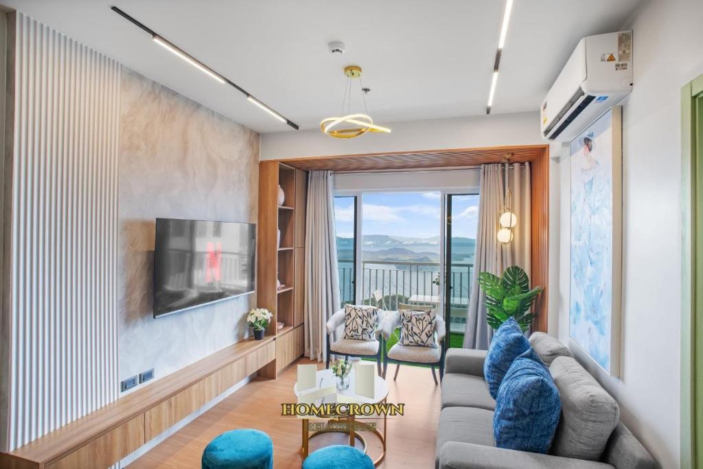 a living room with a couch and a tv at Homecrown Relaxscape in Tagaytay