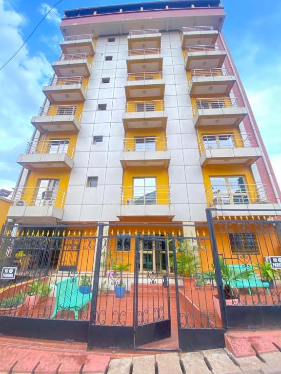 a tall building with a fence in front of it at Résidence shalismi in Yaoundé