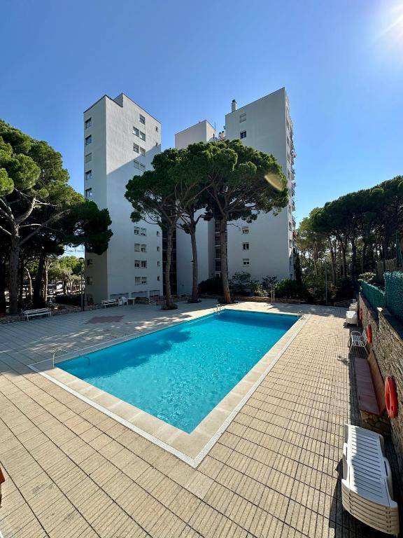 a swimming pool in front of a building at Apartamento Galiria, Pals in Pals