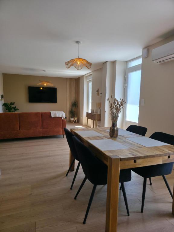 a living room with a wooden table and chairs at L'Escale Cosy avec Terasse in Noidans-lès-Vesoul