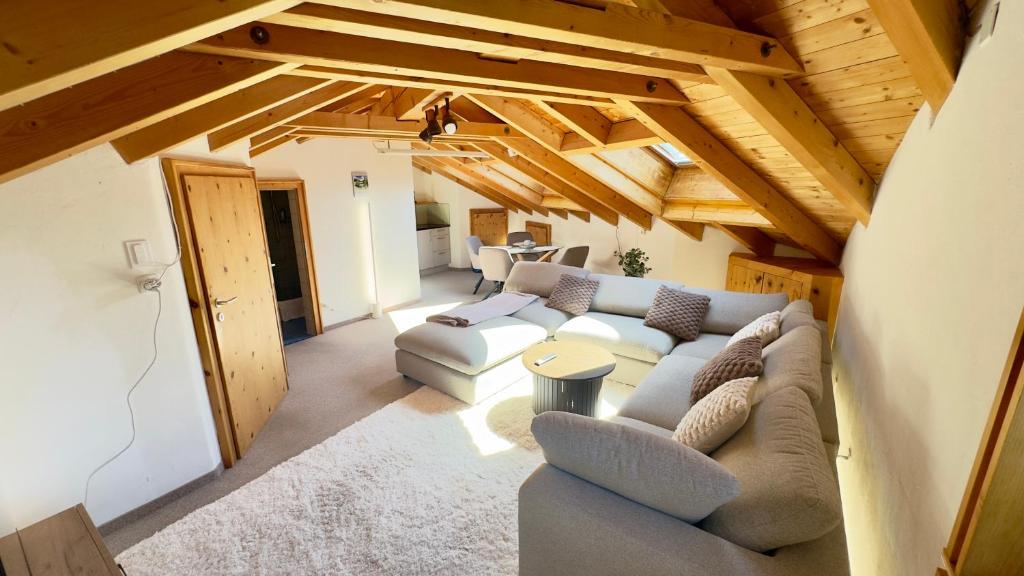 a living room with a couch and a table at Alpine Home with Lounge - 10 min from St Moritz in La Punt-Chamues-ch