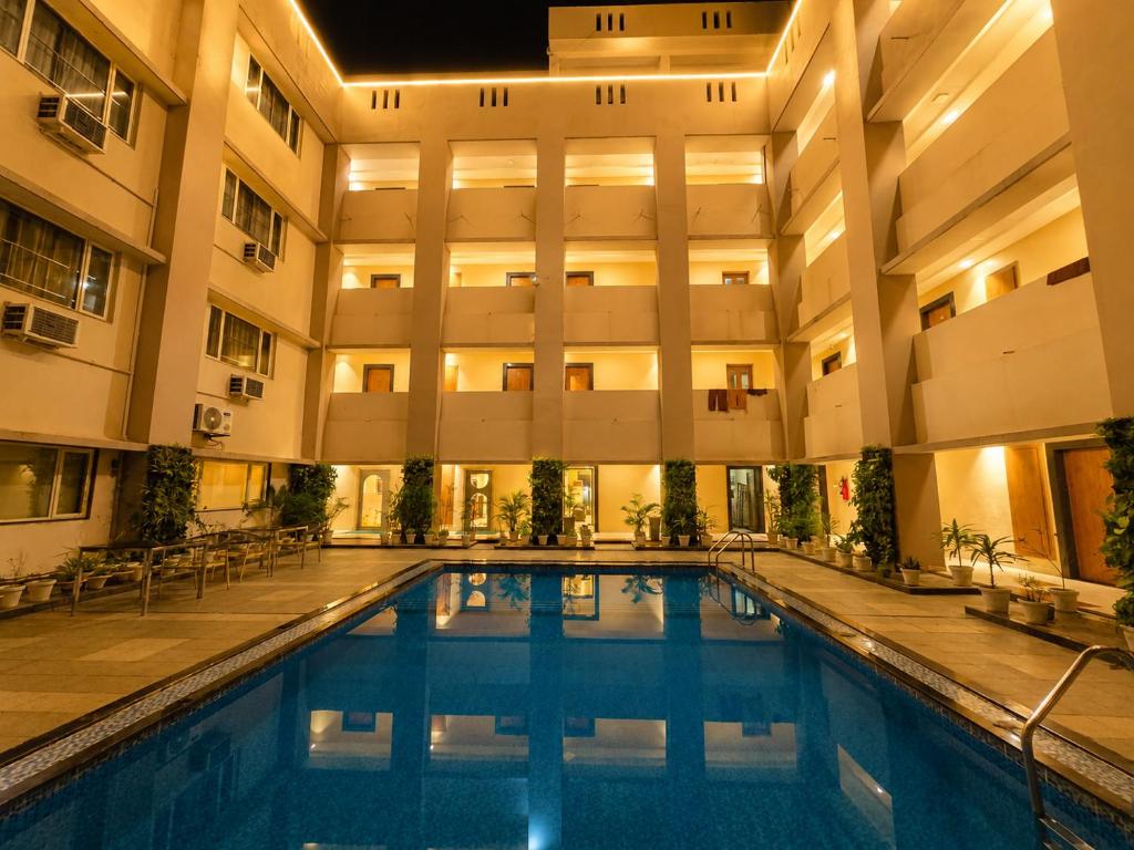 an indoor swimming pool in a building with a hotel at HOTEL in PURI - SWIMMING POOL RB - Near Sea Beach & Shree Jagannath Temple - wifi - Parking - Restaurant - in Puri