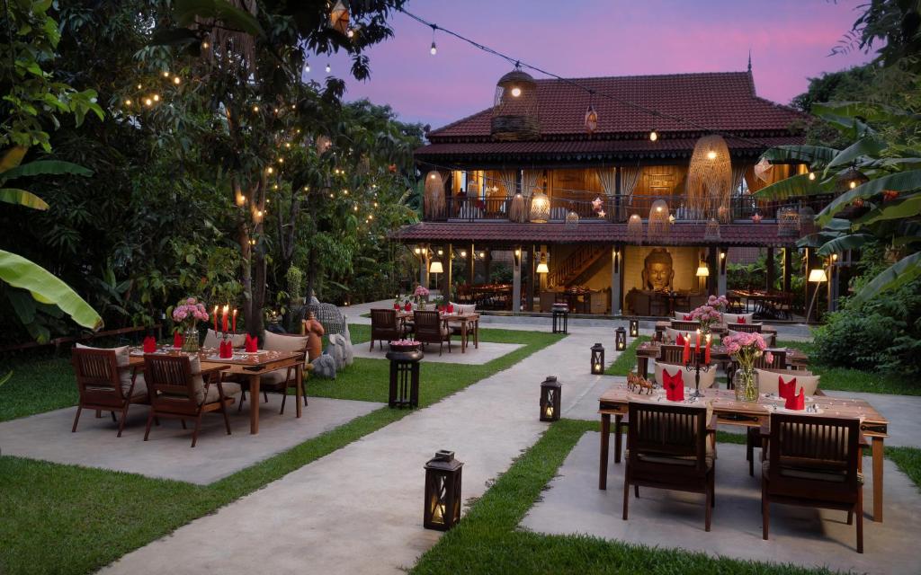 a restaurant with tables and chairs in front of a building at The Community - Siem Reap in Siem Reap
