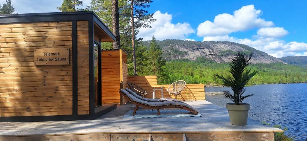 a wooden cabin with a bench and a table at Telemark Camping in Hauggrend