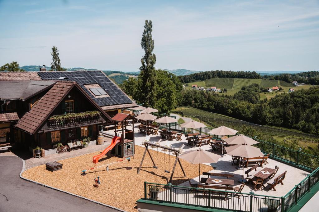an aerial view of a building with a playground with umbrellas at Weingut Pugl in Leibnitz
