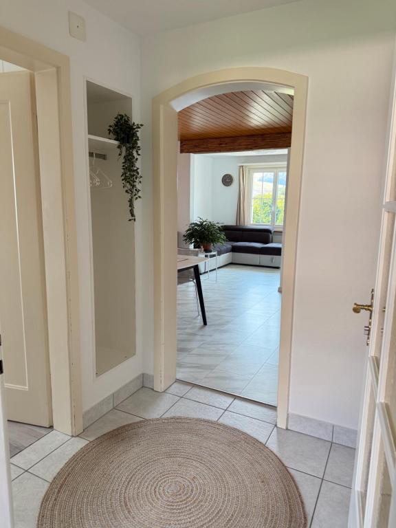 a living room with a door and a rug at Helle Wohnung nahe Bern in Worb