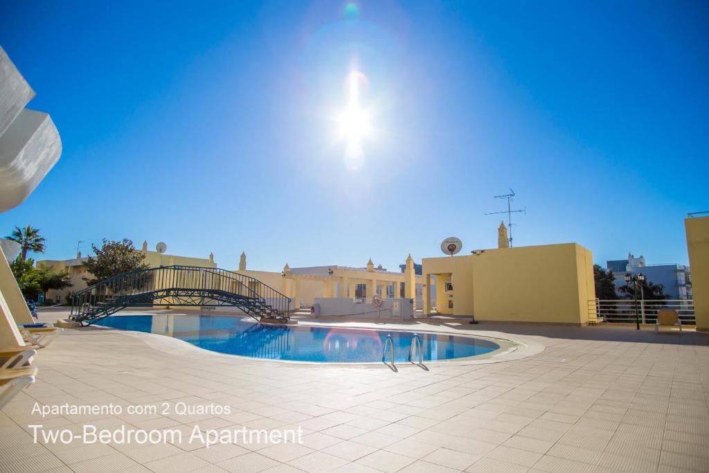 a swimming pool in front of a building at Akisol Lagos Mar in Lagos