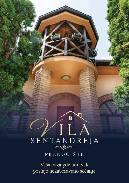 a sign for a building with a tower on it at Vila Sentandreja in Subotica