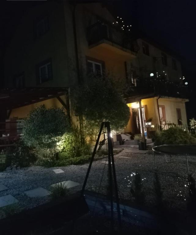 a house at night with a swing at Apartamenty Trzcińsko 47 in Janowice Wielkie