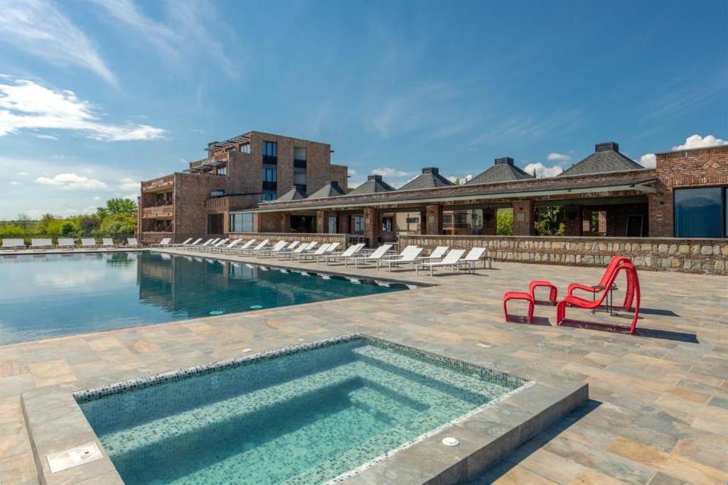 a swimming pool with lounge chairs and a swimming pool at The Wine Station in Tsinandali