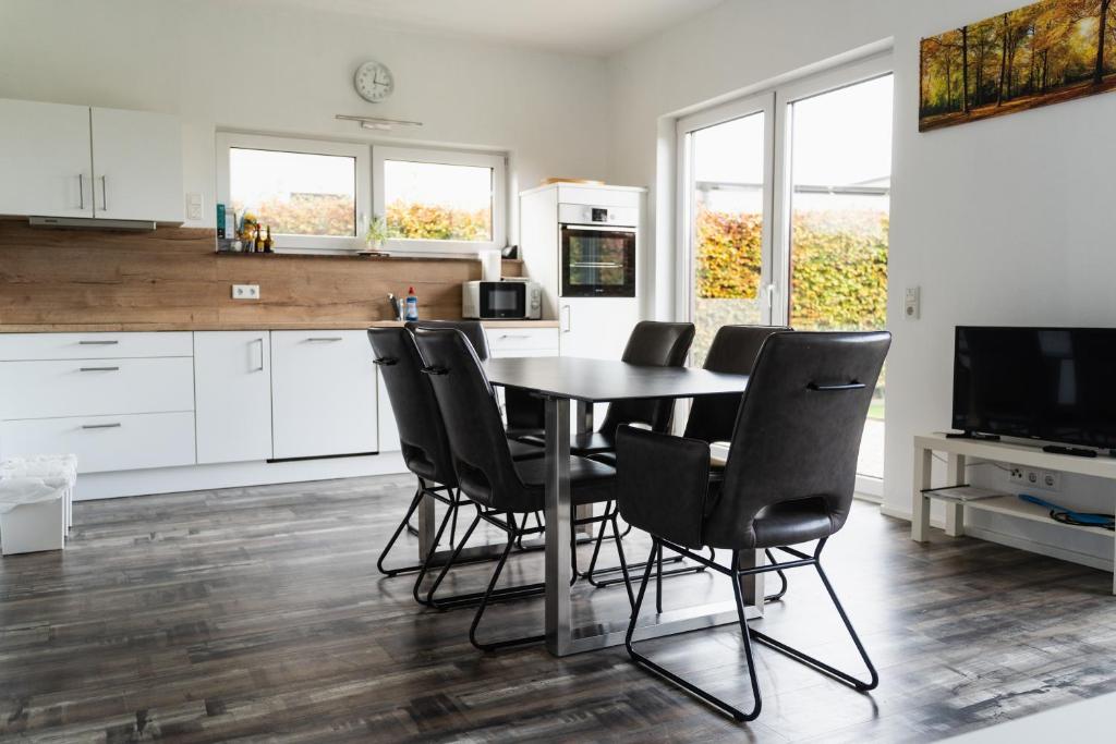 a kitchen with a table and chairs and a television at Seepark Goch-Kessel in Kessel