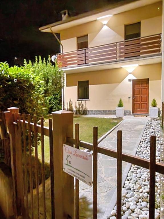 a sign on a fence in front of a house at Casa Leonardo in Tirano