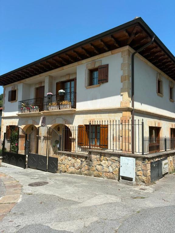 a building with a balcony on the side of it at Balentzenea Rural House in Lesaka
