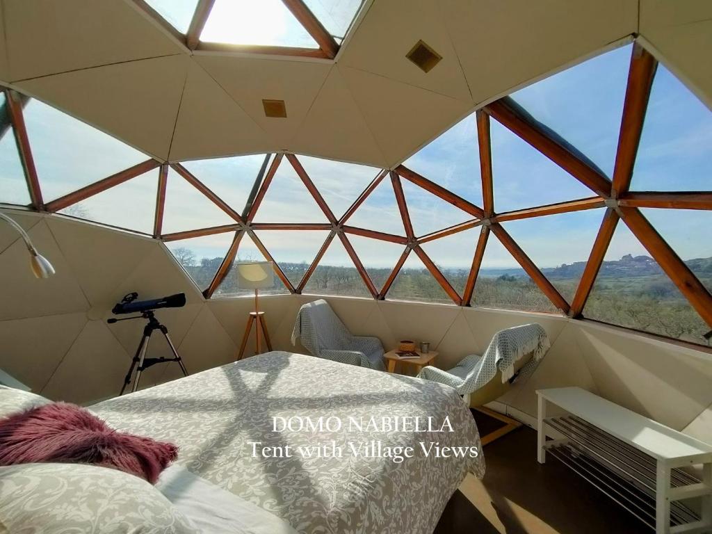 a room with a tent with a large window at Mirador de Pideago in Bolea