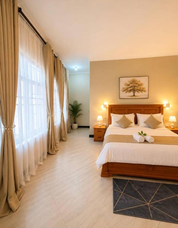 a bedroom with a large bed and a large window at The Serenity Hideaway in Arusha