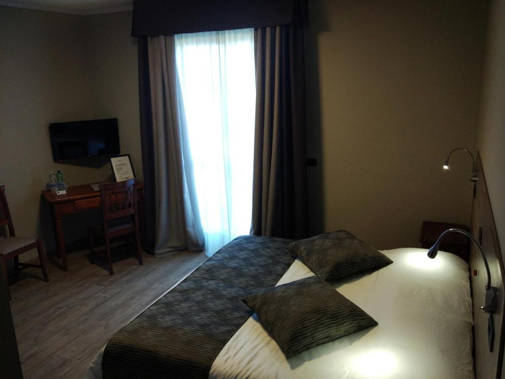 Postel nebo postele na pokoji v ubytování Albergo Ristorante San Biagio