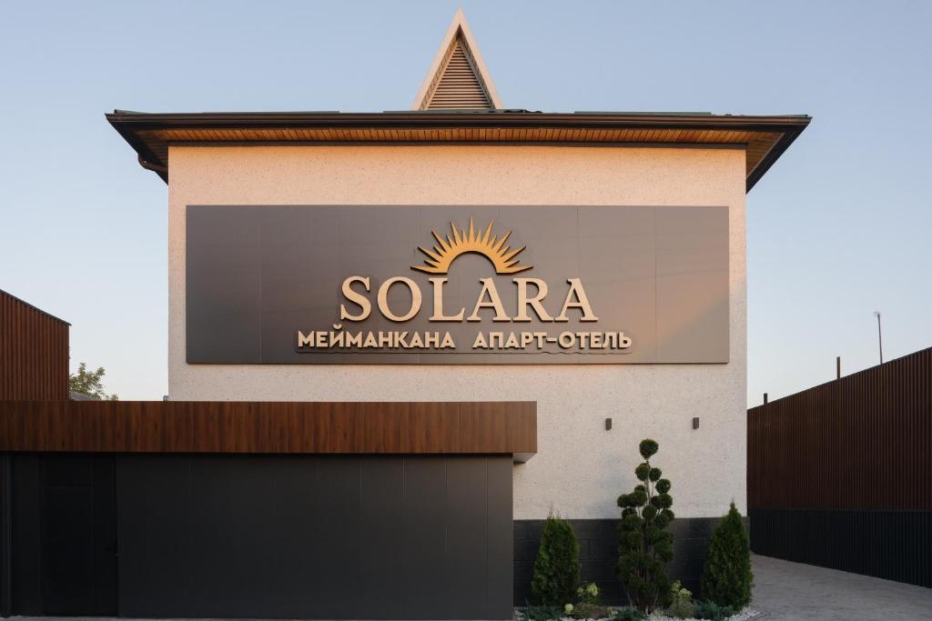 a sign on the side of a building at Solara in Bishkek