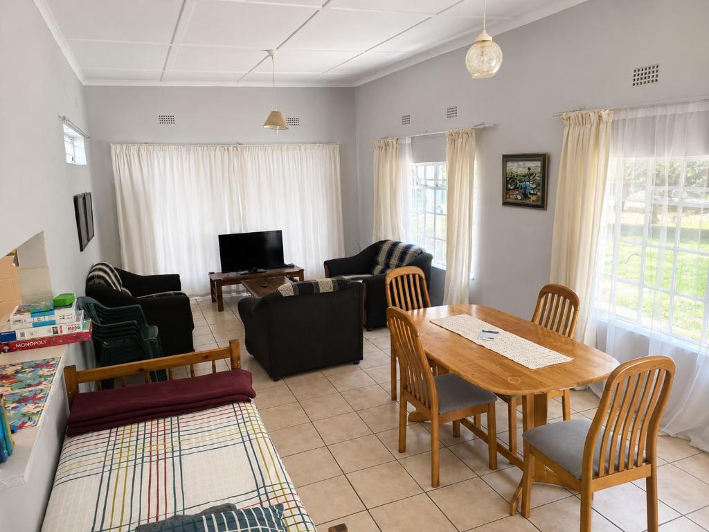 a living room with a table and a couch at Nut Tree Nook in Hazyview