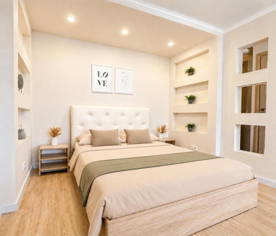 a white bedroom with a large bed and shelves at Габдуллина 79 in Kokshetau