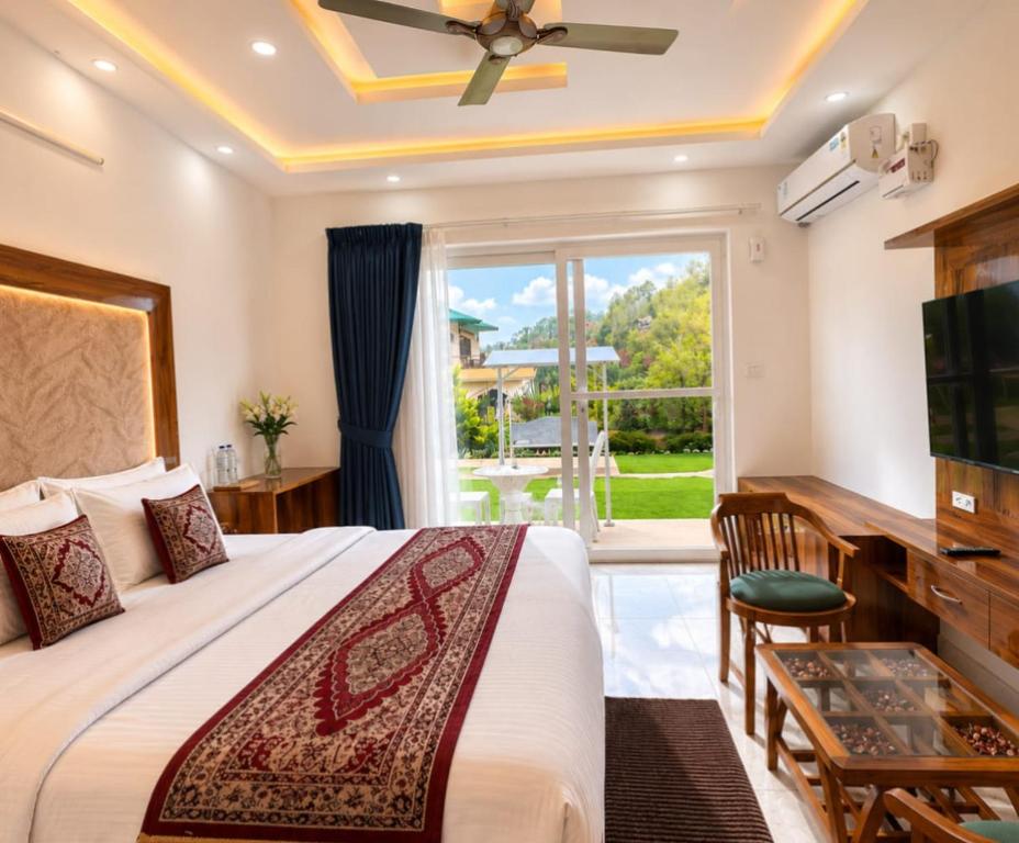 a bedroom with a bed and a large window at Heera Lodge Kasauli By Evening Sky Hotel in Kasauli