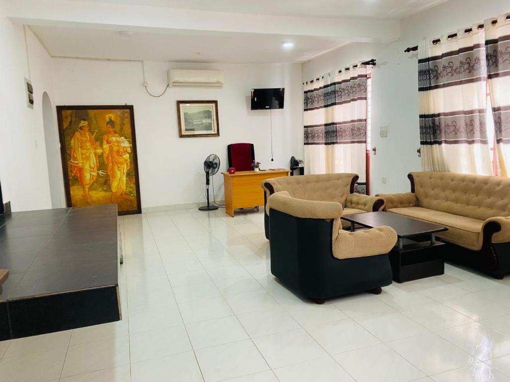 a large living room with couches and a table at Royal place in Mahiyangana