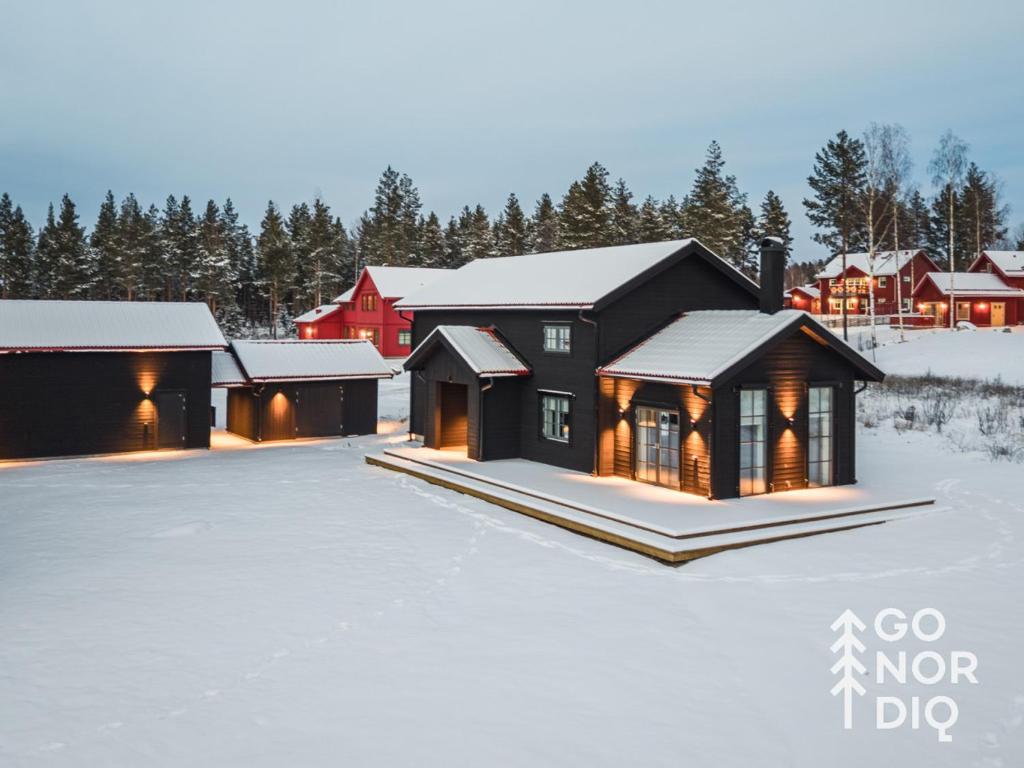a group of buildings in the snow at The Black Bear Lodge in Tällberg