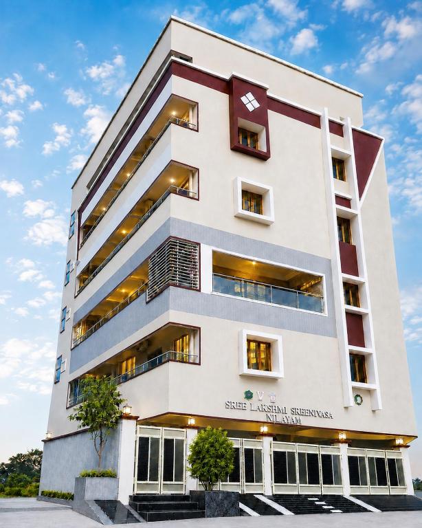 a rendering of a building at SLS Homestay - Luxury AC Service Apartments 1BHK, 2BHK, 3BHK - Direct Flyover to Alipiri Tirumala Gate - Walk to PS4 Pure Veg Restaurants, Supermarkets - Near to National Highway & Padmavathi Amma Temple - Modular Kitchen, Living room -Free Superfast Wifi in Tirupati