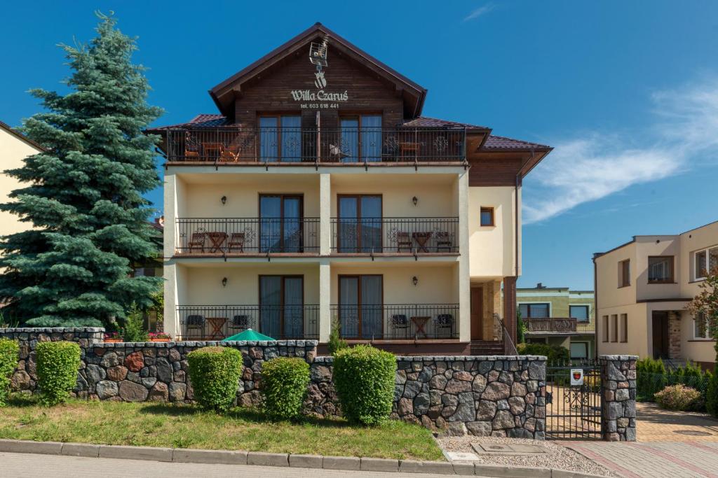 a large building with a tree in front of it at Willa Czaruś in Władysławowo