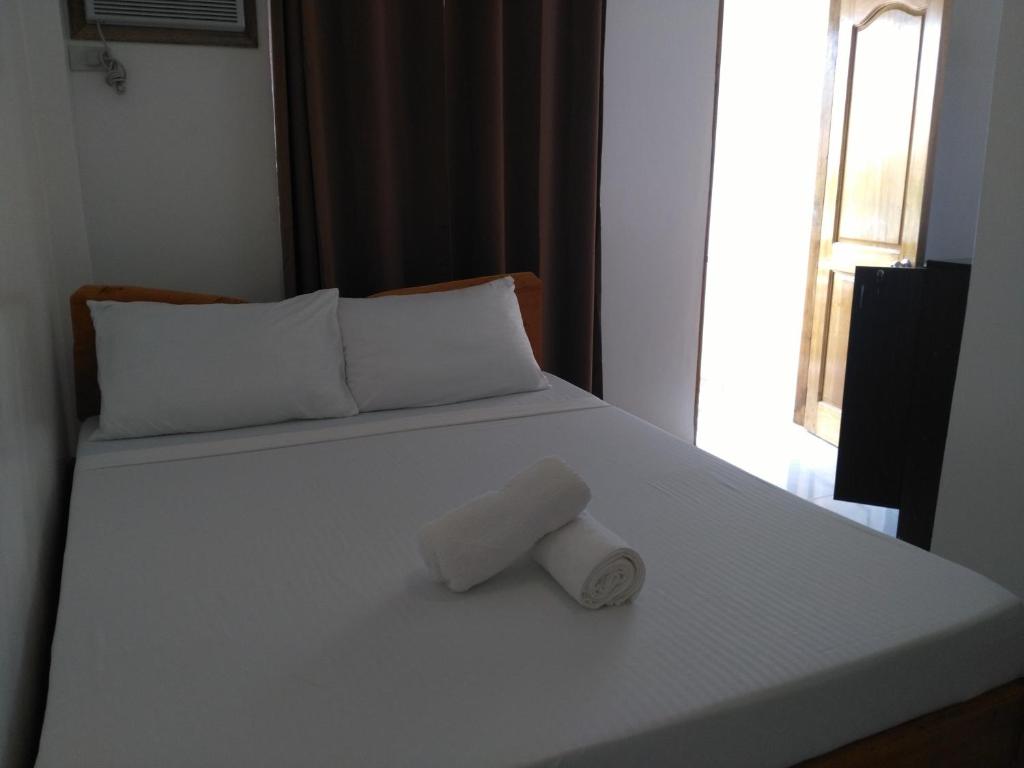 Postel nebo postele na pokoji v ubytování Zenith Inn & Resto Bar