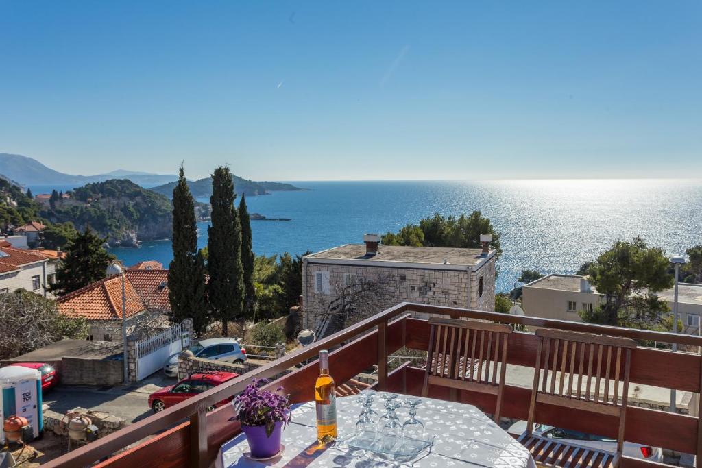 a balcony with a table and a view of the ocean at Apartment Lise in Dubrovnik