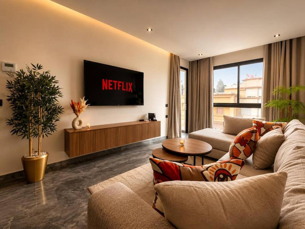 a living room with a couch and a tv at Elegant Studio in Casablanca in Casablanca