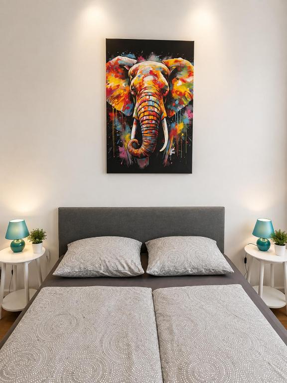 a painting of an elephant hanging on a wall at LF Sports & Spa Hotel in Hannover
