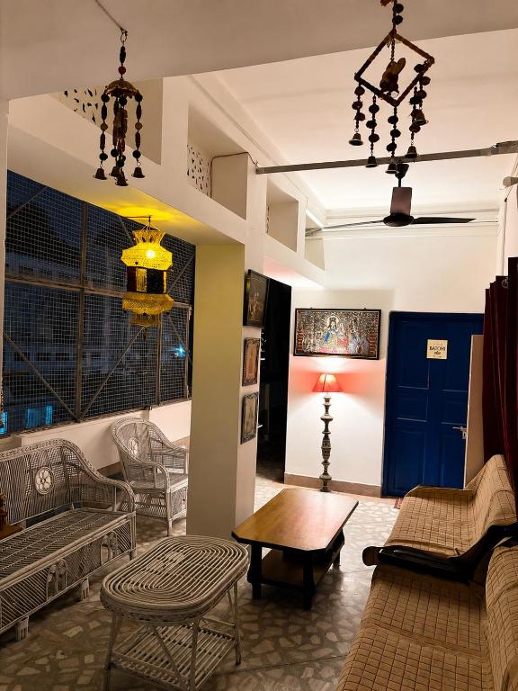a living room with chairs and a table at Inka Kashi Hostel Varanasi in Varanasi