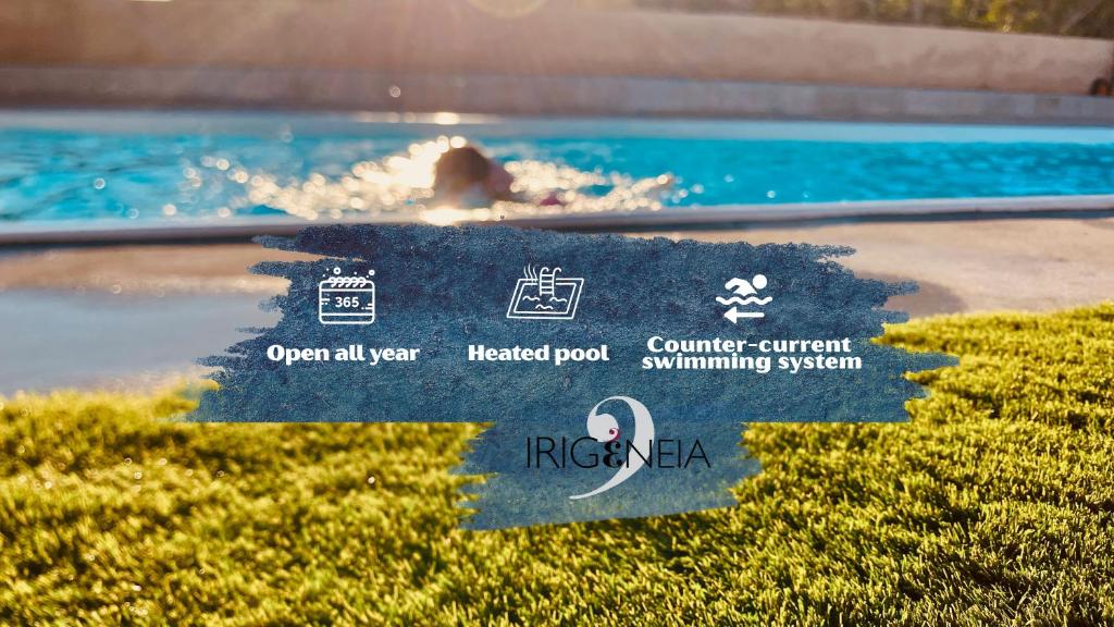 a swimming pool with a person in the water at Irigeneia Hotel in Perissa